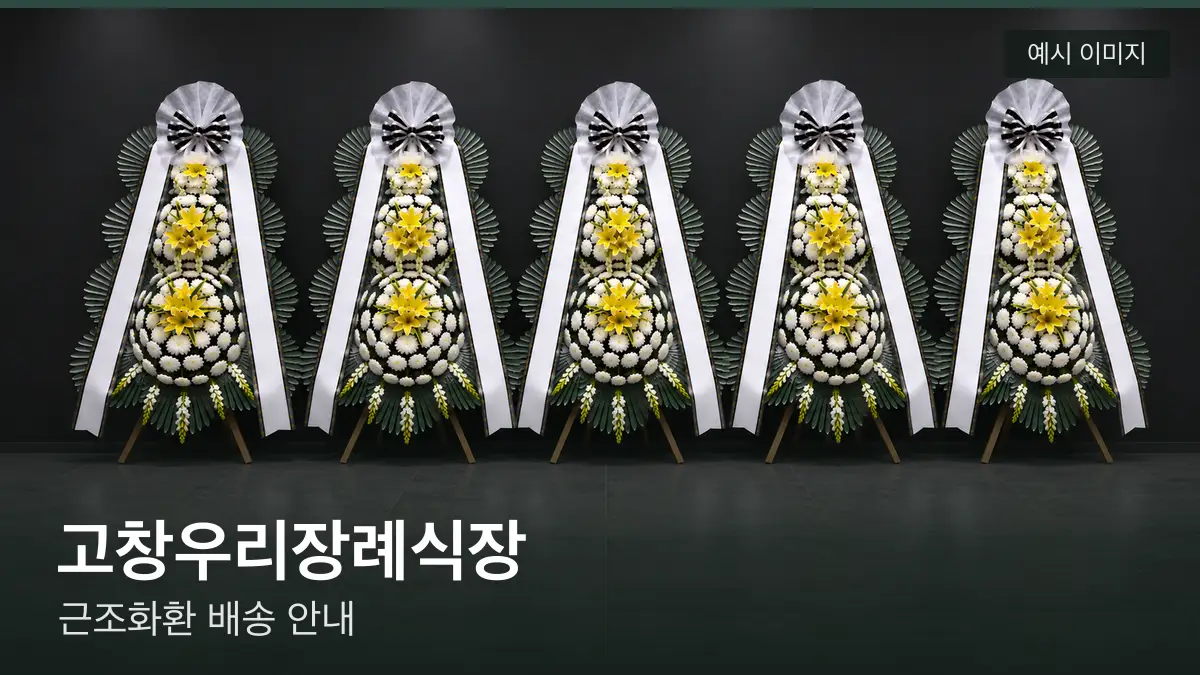 고창우리장례식장 근조화환 예시 이미지 — 흰 국화 3단 근조화환이 벽을 따라 나란히 놓인 모습