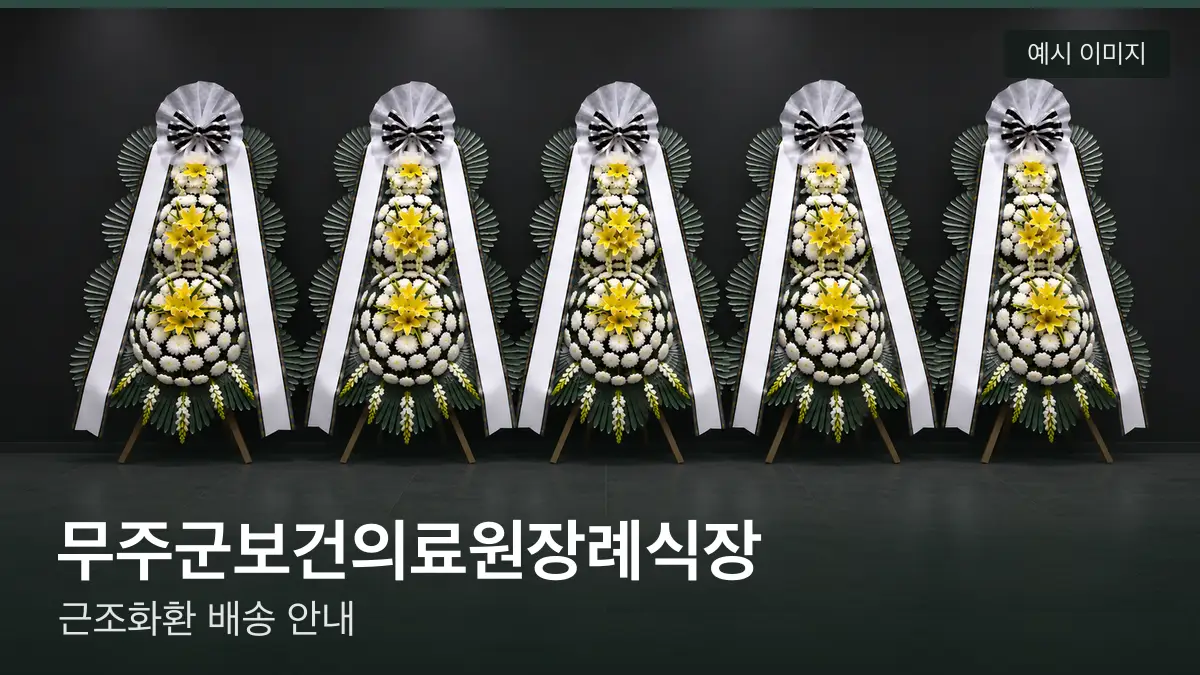 무주군보건의료원장례식장 근조화환 예시 이미지 — 흰 국화 3단 근조화환이 벽을 따라 나란히 놓인 모습